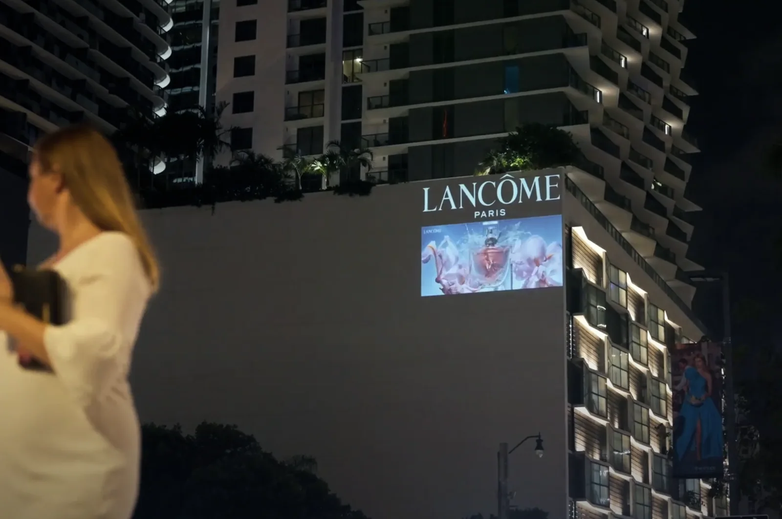 Projection advertising campaign placed on a building wall at night