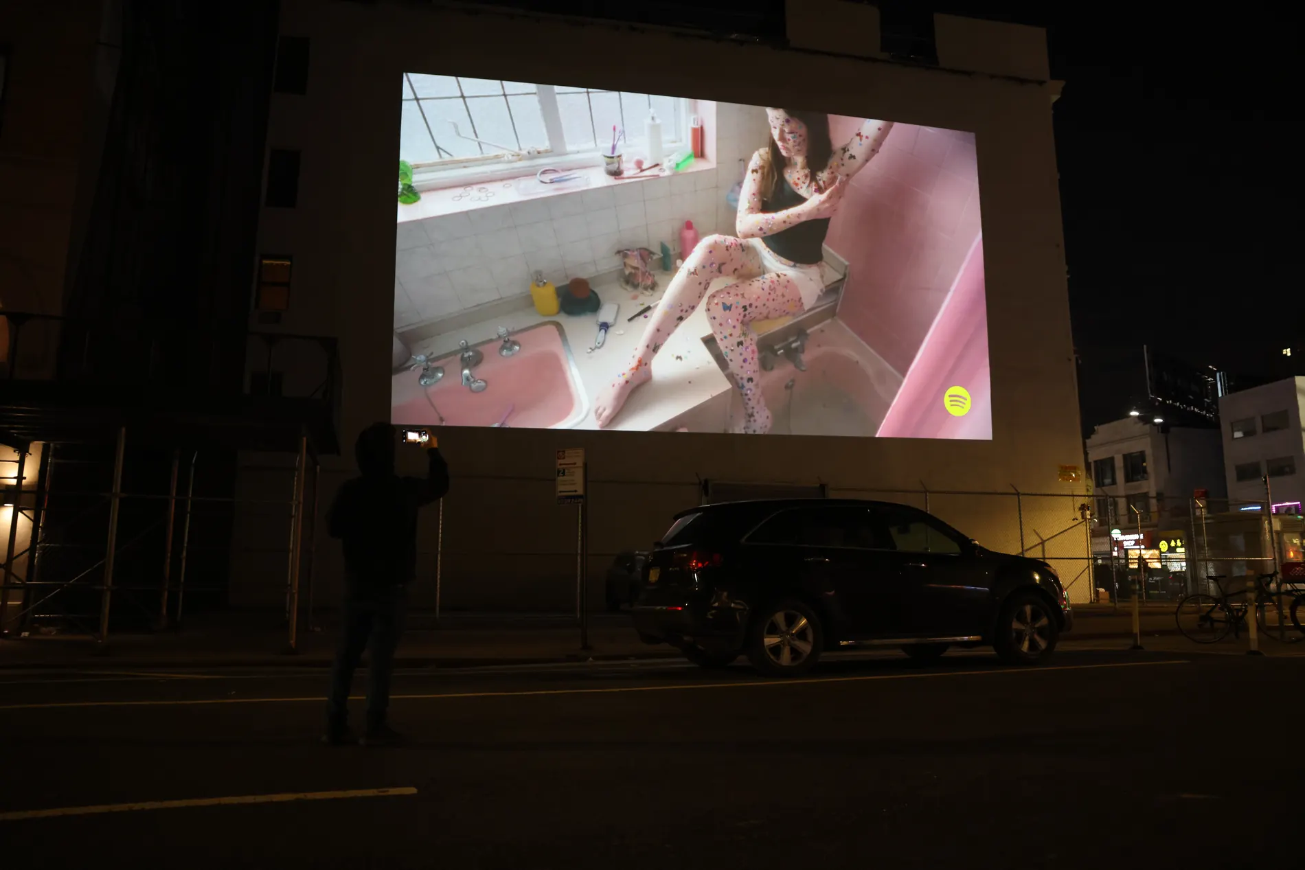 Person recording projection advertising with a phone
