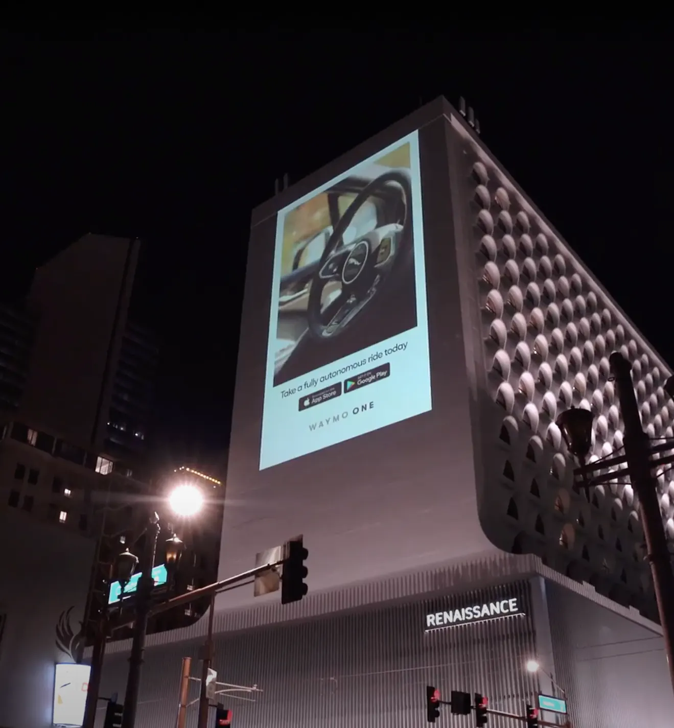 Tall projection advertising placement on a city building at night